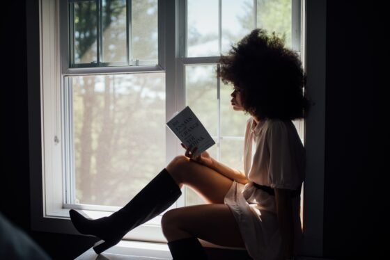 mujer con botas leyendo